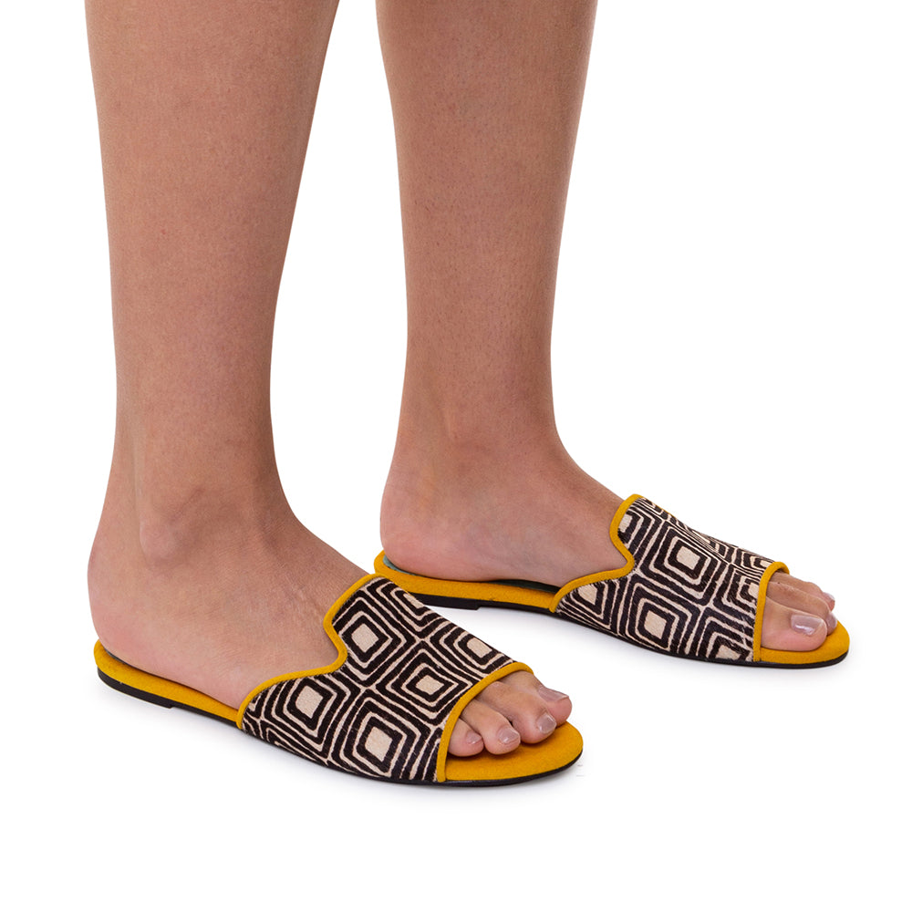 a woman's feet wearing a pair of sandals