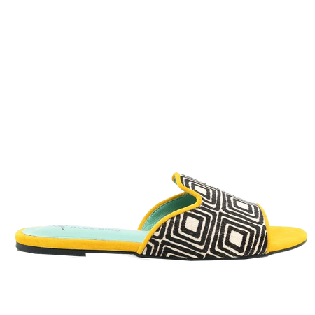 a woman's yellow and black slip on sandals
